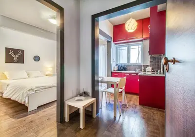 a bedroom with a bed and a table and a kitchen at Beautiful and cozy studio next to Athens center in Athens