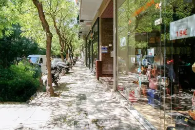 a reflection of a sidewalk in a store window at Beautiful and cozy studio next to Athens center in Athens