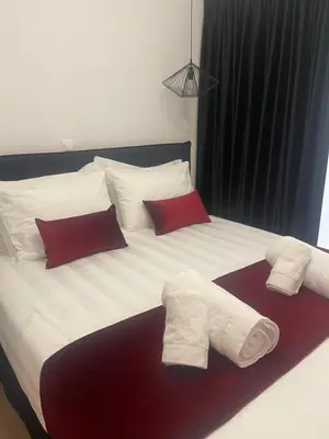 a bed with two towels on top of it at Acropolis Exclusive Apartment in Athens
