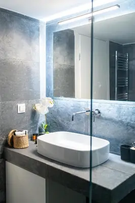 a bathroom with a sink and a mirror at Acropolis Exclusive Apartment in Athens