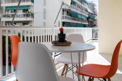 a table and chairs on a balcony with a table at Acropolis Exclusive Apartment in Athens
