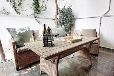 a table with a bottle of wine and a glass at ACROPOLIS GATE in Athens