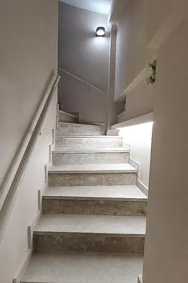 a stairway with white stairs in a building at ACROPOLIS GATE in Athens