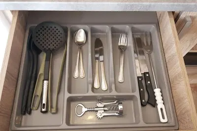 a tray with utensils and cutlery in a drawer at Quiet Studio with Athens View in Athens