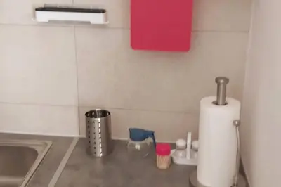 a kitchen counter with a sink and a roll of paper towels at Quiet Studio with Athens View in Athens