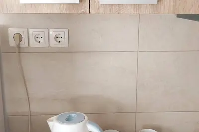 a bathroom with two electrical switches with faces on the wall at Quiet Studio with Athens View in Athens