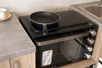 a frying pan on top of a stove in a kitchen at Quiet Studio with Athens View in Athens
