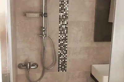 a bathroom with a shower with a glass door at Quiet Studio with Athens View in Athens