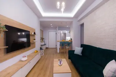 a living room with a couch and a tv at Luxurious apt near Ampelokipoi Metro station in Athens