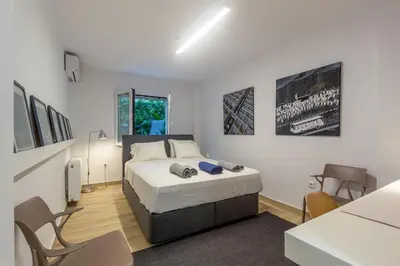 a bedroom with a bed and a table and chairs at A newly fully renovated studio in Athens