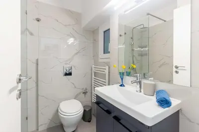 a bathroom with a sink and a toilet and a shower at A newly fully renovated studio in Athens