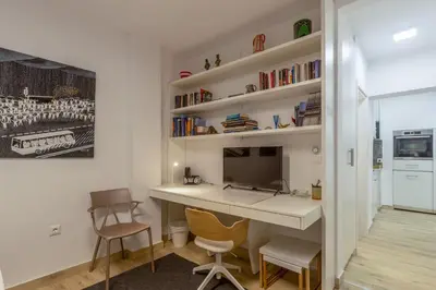 a home office with a desk and chairs at A newly fully renovated studio in Athens