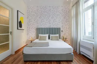 a bedroom with a large bed and a wall at Your 4 bdrm Dream House Acropolis View & Jacuzzi in Athens