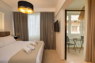 a bedroom with a bed with towels on it at Dema Luxury Suites - Perikleous E6 in Athens