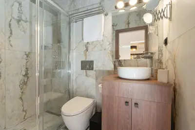 a bathroom with a toilet and a sink and a shower at Dema Luxury Suites - Perikleous E6 in Athens