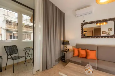 a living room with a couch and a table at Dema Luxury Suites - Perikleous E6 in Athens