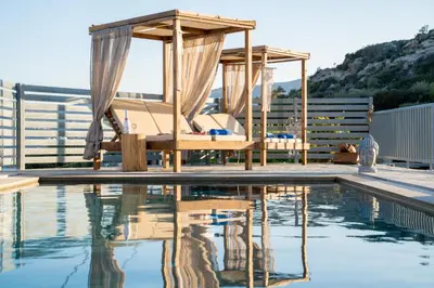 a pool with a bed and a gazebo at Be Home Sea View in Porto Rafti