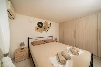 a bedroom with a bed with towels on it at Be Home Sea View in Porto Rafti