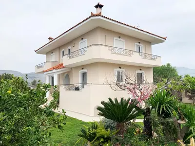 a large white house with a roof at Vintage Manor in Anavissos