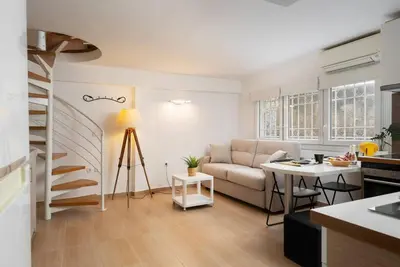 a living room with a couch and a table at Modern Two Level Apartment in the Heart of Athens in Athens