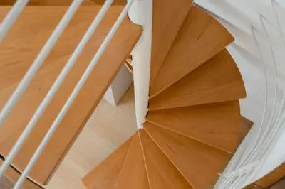 a wooden spiral staircase in a house at Modern Two Level Apartment in the Heart of Athens in Athens