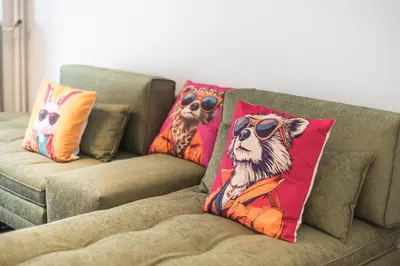 a couch with two pillows with a dog wearing sunglasses at Goudi 4th Floor Greece Apartments in Athens