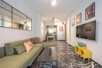 a living room with a couch and a table at Goudi 4th Floor Greece Apartments in Athens