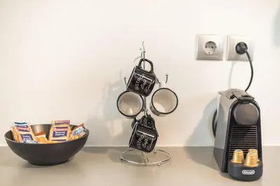 a table with a bowl of food and a hair dryer at Goudi 4th Floor Greece Apartments in Athens