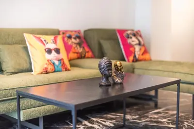 a coffee table in a living room with a couch at Goudi 4th Floor Greece Apartments in Athens