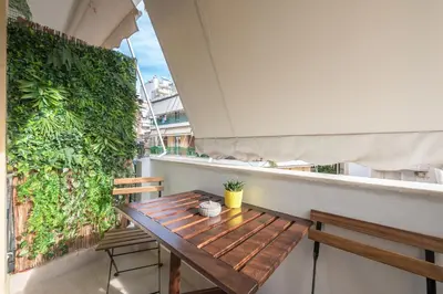 a wooden table and two chairs on a balcony at Goudi 4th Floor Greece Apartments in Athens