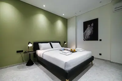 a bedroom with a bed with a zebra picture on the wall at Athenian Island Project in Athens