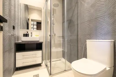 a bathroom with a shower and a toilet and a sink at Athenian Island Project in Athens
