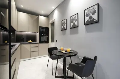 a kitchen with a table and chairs in a room at Athenian Island Project in Athens