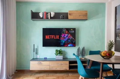 a living room with a table and blue walls at Blue Ark Wanderlust in Athens