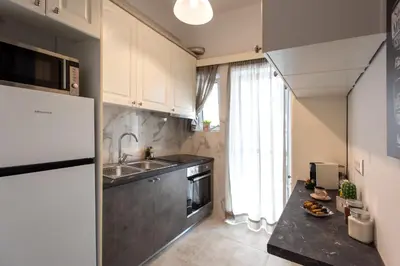 a kitchen with a sink and a refrigerator at Blue Ark Wanderlust in Athens