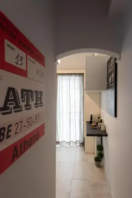 a room with a hallway with a counter and a kitchen at Blue Ark Wanderlust in Athens