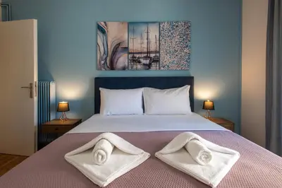a bedroom with a bed with towels on it at Blue Ark Wanderlust in Athens