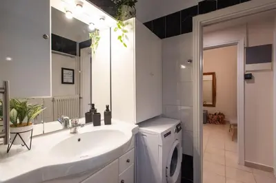 a bathroom with a sink and a washing machine at Blue Ark Wanderlust in Athens