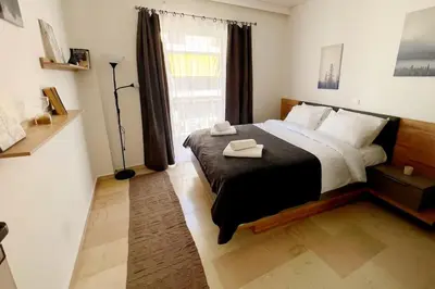 a bedroom with a large bed and a window at Minimal 3BR Apartment in Athens in Athens