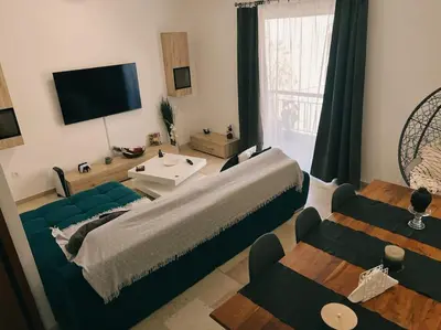 a living room with a large bed and a couch at Minimal 3BR Apartment in Athens in Athens