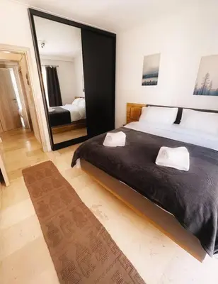 a bedroom with a large bed and a large mirror at Minimal 3BR Apartment in Athens in Athens