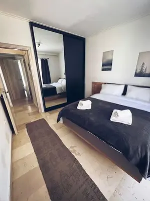 a bedroom with a large bed and a large mirror at Minimal 3BR Apartment in Athens in Athens