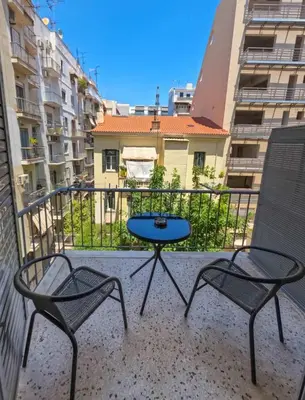 a patio with two chairs and a table on a balcony at Comfortable apt, next to Archeological museum! in Athens
