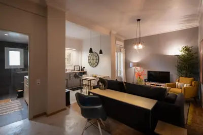 a living room with a couch and a table at Athens City Apartment the Nest of Filoxenia in Athens