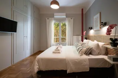 a bedroom with a large bed with towels on it at Athens City Apartment the Nest of Filoxenia in Athens