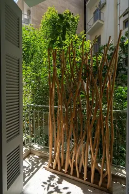 a wooden fence with a plant in it at Athens City Apartment the Nest of Filoxenia in Athens