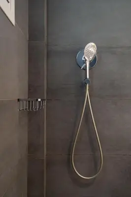 a shower with a shower head in a bathroom at Athens City Apartment the Nest of Filoxenia in Athens