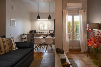 a living room with a couch and a table at Athens City Apartment the Nest of Filoxenia in Athens