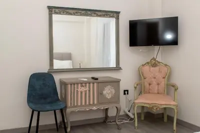 a room with a mirror and a chair and a desk at Esperidon Luxury Apartment Glyfada in Athens