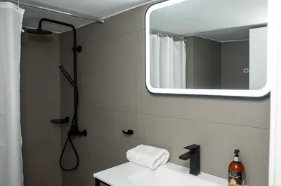 a bathroom with a sink and a mirror at Esperidon Luxury Apartment Glyfada in Athens